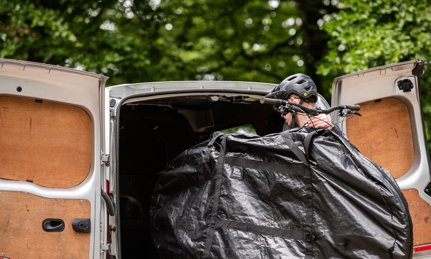Bike inside a RoughSac being loaded into a van